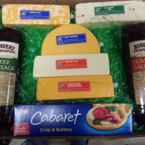 Cheese and Meat Lovers, gift box with cheeses, meats and a box of crackers with grass on a table