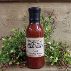 Peach Grilling Sauce, Osceola Cheese grilling sauce bottle on a table