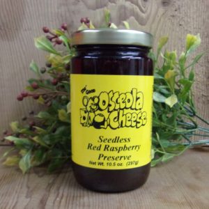 Seedless Red Raspberry Preserve, Osceola Cheese preserve jar on a table