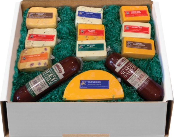 Variety Pack gift package  of cheeses and meats in a gift box with grass on a table