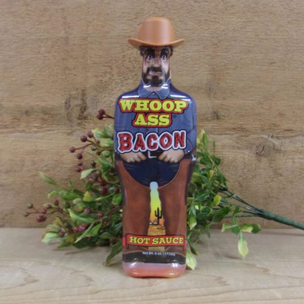 Whoop Ass Bacon Hot Sauce bottle on a table