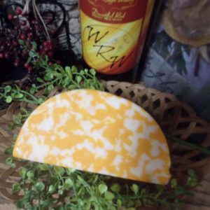 Co-Jack Longhorn cheese half moon cheese block in a bowl on a table