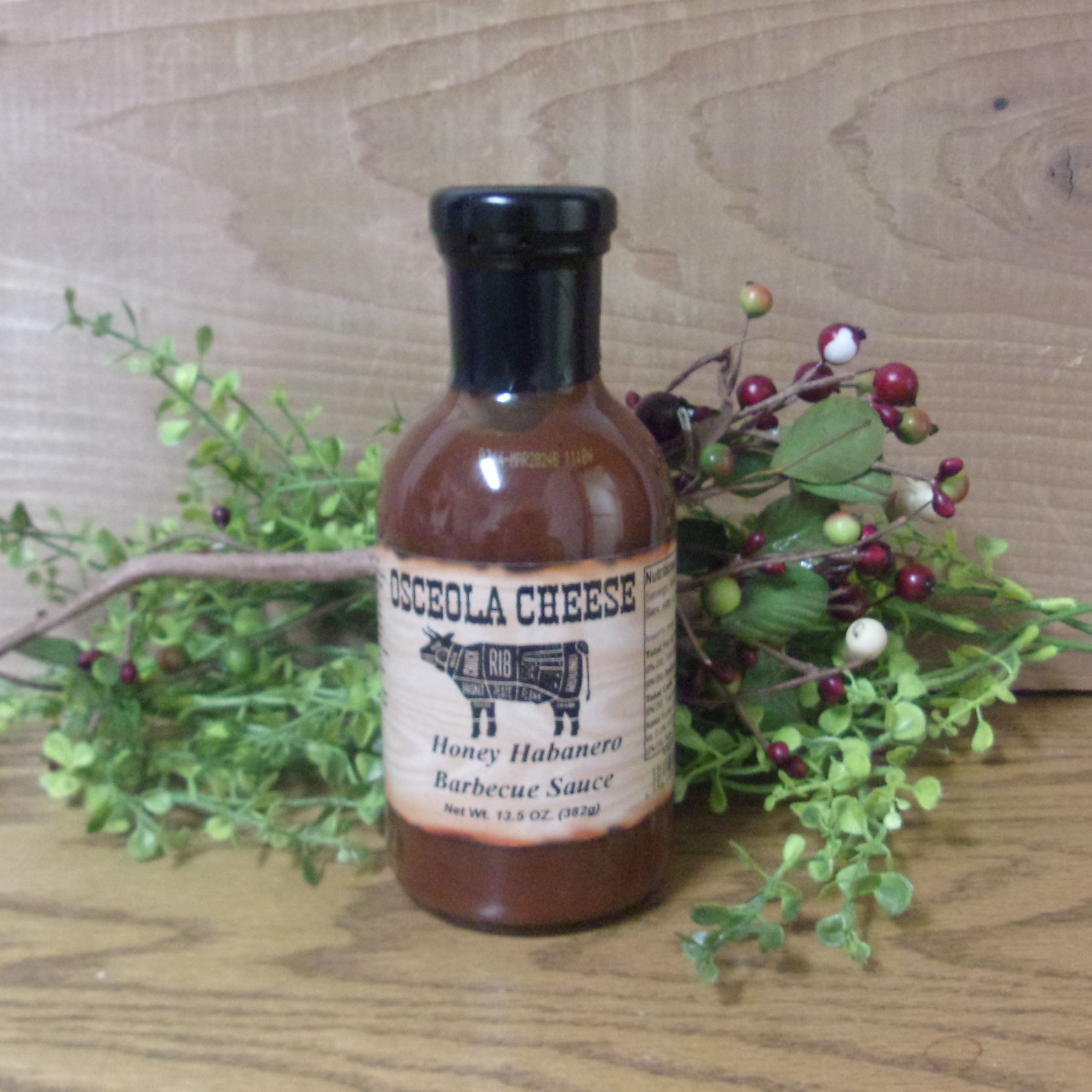 Honey Habanero Barbecue Sauce bottle, Osceola Cheese sauce on a table