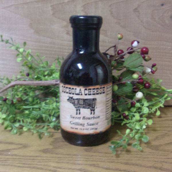Sweet Bourbon Grilling Sauce bottle,  Osceola Cheese sauce on a table