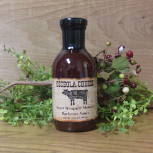 Sweet Mesquite Mesquite Molasses Barbecue Sauce bottle,  Osceola Cheese sauce on a table