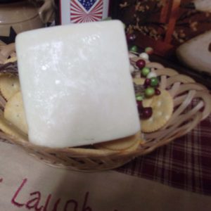 Applewood Smoked Gruyere cheese block in a bowl on a table