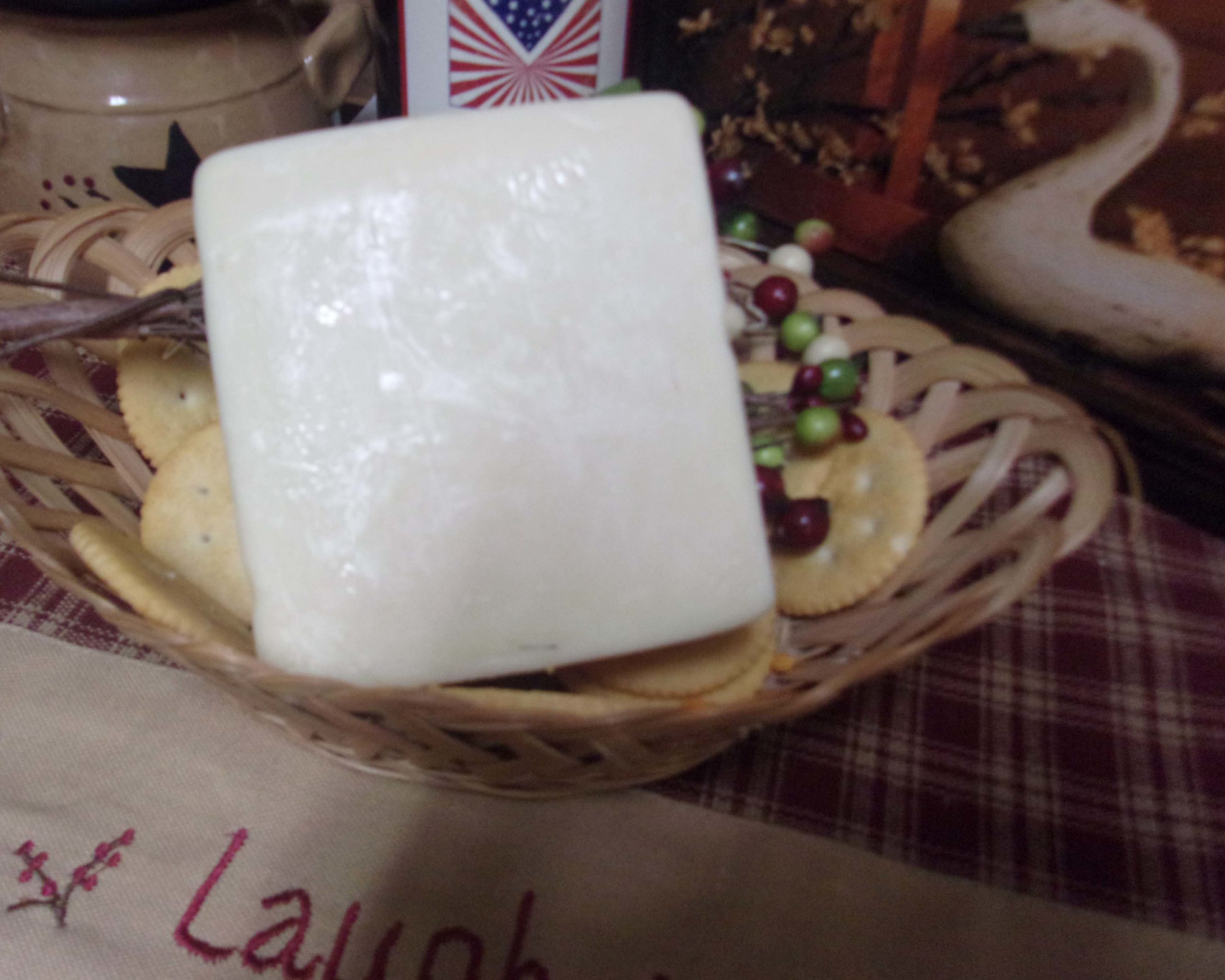 Applewood Smoked Gruyere cheese block in a bowl on a table