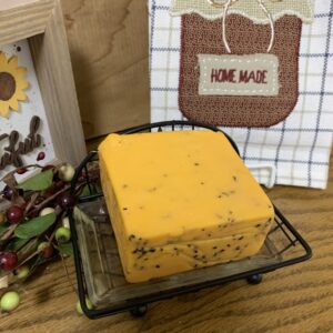 Tuscan Rosemary Cheddar  cheese block on a table