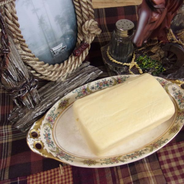 Butter Kaese cheese block on a plate on a table