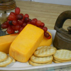 Hickory Smoked 5 Year Cheddar cheese on a plate on a table