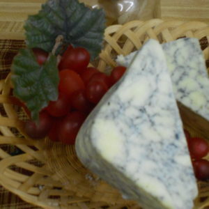Hickory Smoked Blue Marble Monterey Jack cheese blocks in a basket on a table