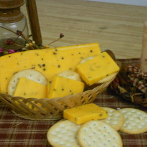 Hickory Smoked Black Pepper Cheddar cheese pieces in a basket on a table