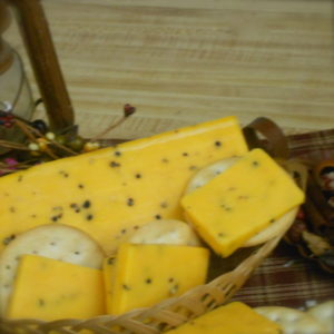 Black Pepper Cheddar, blocks of cheese in a basket on a table