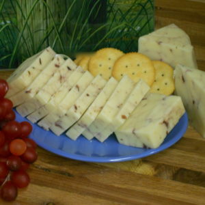 Cranberry White Cheddar cheese blocks on a plate on a table