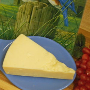 Asiago cheese block on a plate on a table