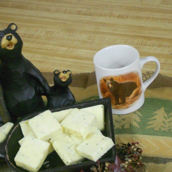 Hickory Smoked Onion & Chive Cheddar cheese slices in a bowl on a table