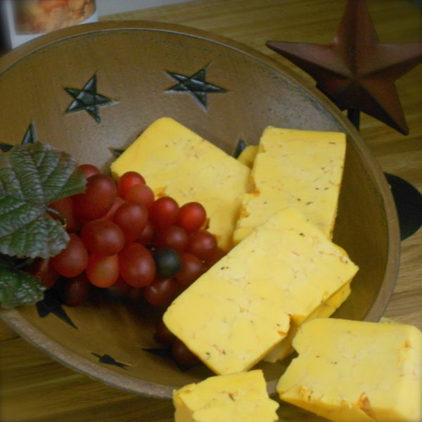 Cajun Cheddar, cheese blocks in a bowl on a table