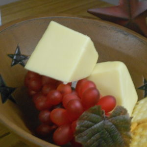 Hickory Smoked Mozzarella cheese blocks in a bowl on a table