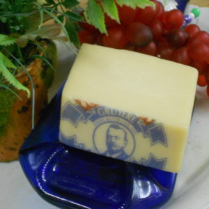 Gruyere cheese block on a plate on a table