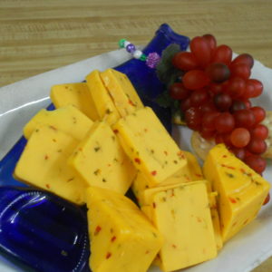 Hickory Smoked Hot Pepper Cheddar cheese blocks on a plate on a table