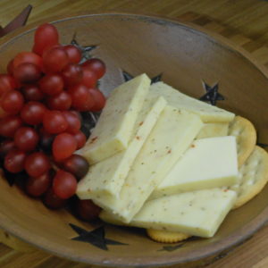Hickory Smoked Tomato and Basil Monterey Jack cheese slices in a bowl on a table