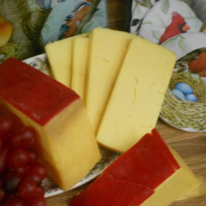 Natural Gouda cheese blocks on a plate on a table