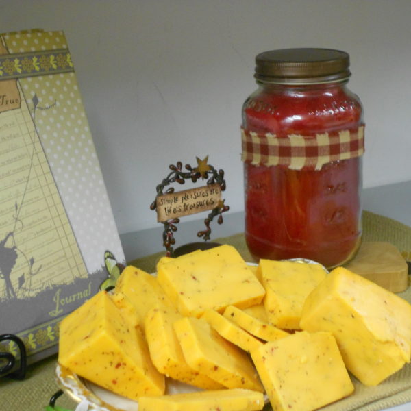 Hickory Smoked Tomato & Basil Cheddar cheese blocks on a plate on a table