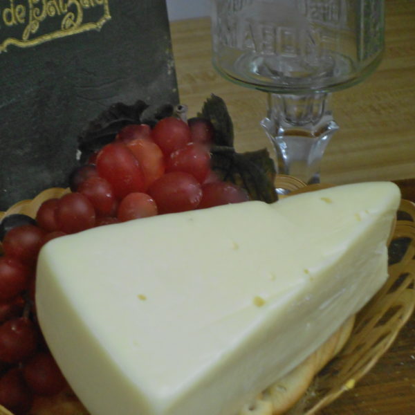 Fontina cheese block in a basket on a table