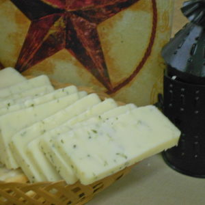Horseradish & Chive Cheddar cheese blocks in a basket on a table