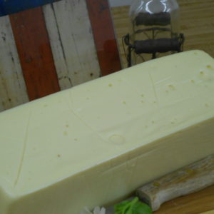 5 Pound White American cheese block on a table