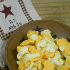 Mixed White and Yellow Curds, yellow and white cheese pieces in a bowl on a table