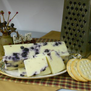 Hickory Smoked Blueberry Cheddar blocks on a plate on a table