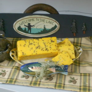 Hickory Smoked Cheddar and Rye cheese blocks on a plate on a table