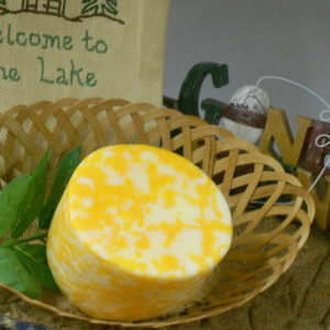 Colby Swiss Swirl cheese block in a basket on a table