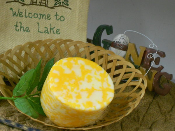 Colby Swiss Swirl cheese block in a basket on a table