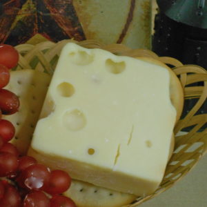 Extra Sharp Aged Swiss cheese block in a basket on a table