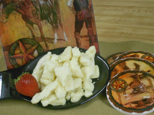 White Cheddar with Dill Curds cheese pieces on a plate