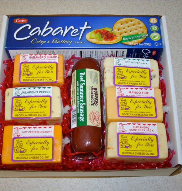 The Hot Shot cheese, meat and crackers in a gift box with grass on a table